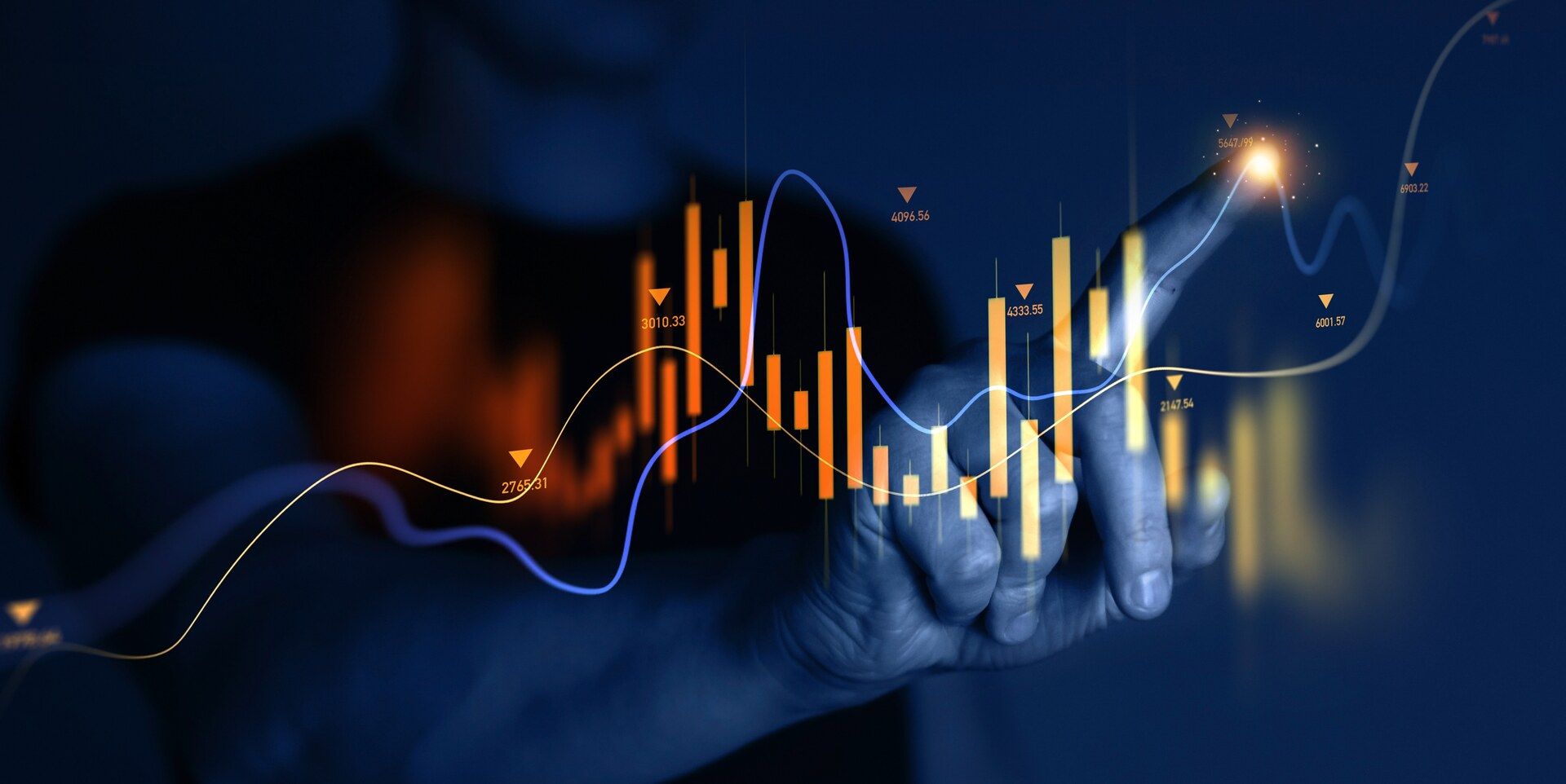 A hand tracing the rising line of a candlestick price chart