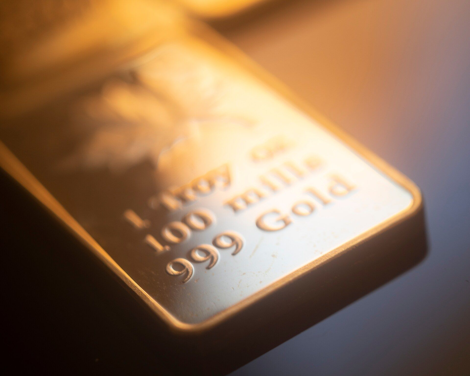 Close-up of fine gold bullion bars, the nearest stamped 999 gold
